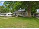 Charming home with lush green lawn, mature trees, and inviting curb appeal at 1240 Hamilton Dr, Noblesville, IN 46060
