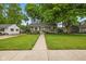 Charming one-story home with a well-manicured lawn, a tree, and a welcoming walkway at 1240 Hamilton Dr, Noblesville, IN 46060
