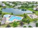 Aerial photo showcases a community pool, playground, lake, and manicured green spaces at 12994 Dekoven Dr, Fishers, IN 46037