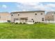 Manicured backyard showcasing a large lawn, white picket fence, tasteful landscaping and fire pit at 12994 Dekoven Dr, Fishers, IN 46037
