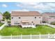Beautiful backyard featuring manicured lawn, fire pit, landscaping, and a white picket fence at 12994 Dekoven Dr, Fishers, IN 46037