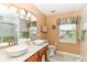 Bathroom features double sinks, tile accents, and stylish lighting fixtures at 12994 Dekoven Dr, Fishers, IN 46037