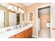Bathroom vanity features double sinks and a large mirror, with a doorway leading to another room at 12994 Dekoven Dr, Fishers, IN 46037