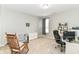 A bright bedroom featuring neutral tones, carpeted floors, and a comfortable rocking chair, perfect for relaxation at 12994 Dekoven Dr, Fishers, IN 46037