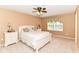 Comfortable bedroom with neutral walls, ceiling fan and a window offering natural light and street views at 12994 Dekoven Dr, Fishers, IN 46037
