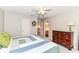 Inviting bedroom with a ceiling fan, and easy access to the bathroom and laundry room at 12994 Dekoven Dr, Fishers, IN 46037