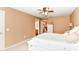 Well-lit bedroom with a ceiling fan, neutral walls, and easy access to an adjoining bathroom at 12994 Dekoven Dr, Fishers, IN 46037