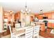 A bright and airy dining room features hardwood floors, modern chandelier, and a large dining table set for a meal at 12994 Dekoven Dr, Fishers, IN 46037