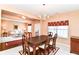Warm dining room connected to living area with a window and a traditional chandelier at 12994 Dekoven Dr, Fishers, IN 46037
