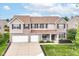 Charming two-story home featuring a manicured lawn, brick accents, and a two-car garage at 12994 Dekoven Dr, Fishers, IN 46037
