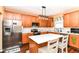 A well-appointed kitchen features stainless steel appliances, white countertops, and dark cabinetry with a center island at 12994 Dekoven Dr, Fishers, IN 46037