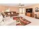 Bright living room with neutral walls, a ceiling fan and large media cabinet at 12994 Dekoven Dr, Fishers, IN 46037