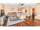 Inviting living room with wood floors, neutral paint, ceiling fan and a blue accent rug at 12994 Dekoven Dr, Fishers, IN 46037