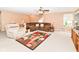 Comfortable living room boasts plush carpeting, a ceiling fan and a recliner at 12994 Dekoven Dr, Fishers, IN 46037