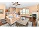An inviting living room with hardwood floors, a fireplace, and a comfortable sofa offers a relaxing space for Gathering and guests at 12994 Dekoven Dr, Fishers, IN 46037