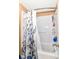 Clean bathroom shower with white tile, a shower curtain, and built-in shelving for toiletries at 12994 Dekoven Dr, Fishers, IN 46037