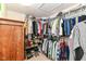 Well-organized walk-in closet features ample storage with rods, shelving and a wooden cabinet at 12994 Dekoven Dr, Fishers, IN 46037