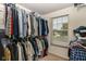 Walk-in closet with extensive hanging storage and a window for natural light at 12994 Dekoven Dr, Fishers, IN 46037