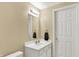 Clean, well-lit bathroom with a white vanity, sink, and a classic framed mirror at 14492 Allison Dr, Carmel, IN 46033