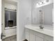Cozy bathroom featuring a bath and shower and a white sink vanity with modern fixtures at 14492 Allison Dr, Carmel, IN 46033
