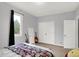 A well-lit bedroom featuring a comfortable bed, a window view, and ample closet space at 14492 Allison Dr, Carmel, IN 46033