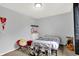 This bedroom features cozy carpet, a comfortable bed, and guitar next to the window at 14492 Allison Dr, Carmel, IN 46033