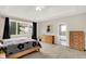 Bright bedroom with neutral carpet, ceiling fan, and access to ensuite at 14492 Allison Dr, Carmel, IN 46033