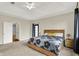 Bright bedroom with neutral carpet, ceiling fan, and a large window at 14492 Allison Dr, Carmel, IN 46033