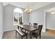 Cozy dining room featuring neutral walls, ample natural light, and a classic chandelier creating an inviting atmosphere at 14492 Allison Dr, Carmel, IN 46033
