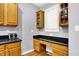 The kitchen features wooden cabinetry, granite countertops, and bonus workspace at 14492 Allison Dr, Carmel, IN 46033