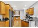 Spacious kitchen with wooden cabinetry, granite countertops, stainless steel appliances, and hardwood flooring at 14492 Allison Dr, Carmel, IN 46033