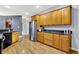 The kitchen features wooden cabinetry, granite countertops, stainless steel appliances, and hardwood flooring at 14492 Allison Dr, Carmel, IN 46033
