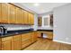 The kitchen features wooden cabinetry, granite countertops, hardwood flooring and bonus workspace at 14492 Allison Dr, Carmel, IN 46033