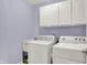 Laundry room including a washer, dryer, sink, and cabinets for storage at 14492 Allison Dr, Carmel, IN 46033