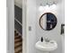 Half bath with neutral paint, round decorative mirror, and pedestal sink at 14492 Allison Dr, Carmel, IN 46033