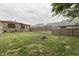 Backyard with a stone exterior house, wooden fence, green grass, and a brick fire pit at 1601 Southern Ave, Beech Grove, IN 46107