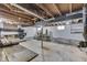 Unfinished basement features wood beams, support pole and room for workshop at 1601 Southern Ave, Beech Grove, IN 46107