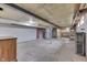 Unfinished basement with brick accent wall and exposed ceiling beams offers renovation possibilities at 1601 Southern Ave, Beech Grove, IN 46107