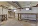 Unfinished basement showcasing potential workspace with exposed overhead beams and natural light at 1601 Southern Ave, Beech Grove, IN 46107