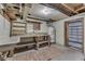 Basement with concrete and wood flooring, work bench, shelving, and hot water heater at 1601 Southern Ave, Beech Grove, IN 46107
