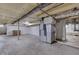A spacious unfinished basement with utilities and beams offers potential for customization at 1601 Southern Ave, Beech Grove, IN 46107