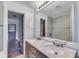 Bathroom featuring double sink vanity with granite countertop and tiled shower at 1601 Southern Ave, Beech Grove, IN 46107