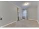 A cozy carpeted bedroom featuring modern curtains and a neutral color palette at 1601 Southern Ave, Beech Grove, IN 46107
