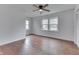 Bright bedroom with hardwood floors, ample natural light, and a ceiling fan at 1601 Southern Ave, Beech Grove, IN 46107
