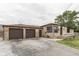 Stone home with two-car garage and long driveway, offering ample parking and curb appeal at 1601 Southern Ave, Beech Grove, IN 46107