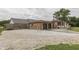 View of stone home with a two-car garage and long driveway offering ample parking at 1601 Southern Ave, Beech Grove, IN 46107