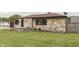 Stone home with a well-maintained lawn and landscape, offering curb appeal at 1601 Southern Ave, Beech Grove, IN 46107
