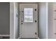 Front door with glass window, framed by white trim with grey walls at 1601 Southern Ave, Beech Grove, IN 46107