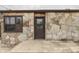 Close-up of a stone home's entrance with a well-maintained walkway and a decorative window at 1601 Southern Ave, Beech Grove, IN 46107