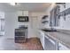Kitchen featuring white cabinets, laminate countertops, and stainless steel appliances at 1601 Southern Ave, Beech Grove, IN 46107
